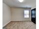 Bedroom features carpet flooring and a window provides ample natural light at 143 Tara Blvd, Loganville, GA 30052