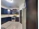 Stylish kitchen with stainless steel appliances, dark cabinetry, and ample counter space at 143 Tara Blvd, Loganville, GA 30052