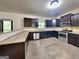 Modern kitchen with stainless steel appliances, granite countertops, and dark cabinetry at 143 Tara Blvd, Loganville, GA 30052