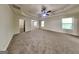 Expansive main bedroom featuring a tray ceiling, ceiling fan, carpet flooring, and natural light at 143 Tara Blvd, Loganville, GA 30052