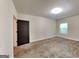 Room with dark wood door and window with stained concrete floors at 143 Tara Blvd, Loganville, GA 30052