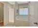 Bright bathroom featuring a soaking tub, and tiled floors at 103 Fuller Ct, Grantville, GA 30220