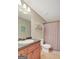 Cozy bathroom features a single sink vanity and shower with a neutral color scheme at 103 Fuller Ct, Grantville, GA 30220