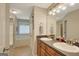 Bathroom with double sinks, granite counters, and a soaking tub at 103 Fuller Ct, Grantville, GA 30220