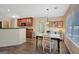 Sunlit dining area features stylish lighting, wood floors, and a seamless flow to the kitchen at 103 Fuller Ct, Grantville, GA 30220