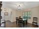 Charming dining area with a stylish light fixture and dark wood table, providing a warm and inviting atmosphere at 103 Fuller Ct, Grantville, GA 30220