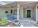 Inviting covered front porch with seating and decorative plants, enhancing the home's curb appeal at 103 Fuller Ct, Grantville, GA 30220