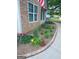 Beautifully landscaped garden bed with a variety of colorful flowers and decorative stonework along the walkway at 103 Fuller Ct, Grantville, GA 30220