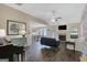 Bright living room featuring dark wood floors, fireplace, and open access to the dining area at 103 Fuller Ct, Grantville, GA 30220