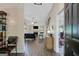 Open-concept living room with hardwood floors, fireplace, and ample natural light from large windows at 103 Fuller Ct, Grantville, GA 30220
