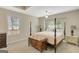 Inviting main bedroom with a four-poster bed, chest, and neutral decor at 103 Fuller Ct, Grantville, GA 30220