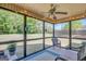 Relaxing sunroom with string lights, ceiling fan, and scenic views of the green backyard at 103 Fuller Ct, Grantville, GA 30220