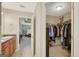 Walk-in closet with custom shelving and ample storage space, conveniently located near the bath at 103 Fuller Ct, Grantville, GA 30220