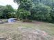 Large, private backyard featuring mature trees, storage shed, and garden area, perfect for outdoor living at 716 Wilkes Dr, Loganville, GA 30052