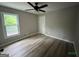 Bedroom with wood floors, ceiling fan, and window at 716 Wilkes Dr, Loganville, GA 30052