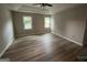 Bedroom featuring wood floors, tray ceilings, and natural lighting at 716 Wilkes Dr, Loganville, GA 30052