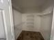Walk-in closet with shelving and tile floor at 716 Wilkes Dr, Loganville, GA 30052