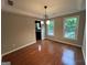 Bright dining room with hardwood floors, chandelier, and natural light from windows at 716 Wilkes Dr, Loganville, GA 30052