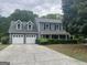 Two-story home with well-kept lawn and two car garage at 716 Wilkes Dr, Loganville, GA 30052
