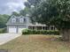 Exterior angle of home with manicured hedges at 716 Wilkes Dr, Loganville, GA 30052