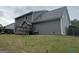 Back exterior featuring a gray siding, a well-maintained lawn, and a privacy fence at 716 Wilkes Dr, Loganville, GA 30052