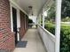 Inviting covered front porch with brick accents and white railings offers a welcoming entrance at 716 Wilkes Dr, Loganville, GA 30052