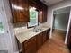 Kitchen view showcasing double sinks, granite countertops and wooden cabinets at 716 Wilkes Dr, Loganville, GA 30052