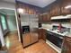 Kitchen featuring stainless steel refrigerator and appliances, and wood cabinets at 716 Wilkes Dr, Loganville, GA 30052