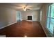 Living room with hardwood floors, a fireplace, and windows overlooking the outdoor space at 716 Wilkes Dr, Loganville, GA 30052