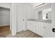 Bright bathroom featuring granite countertops and white cabinets with a doorway view of a closet at 3229 Broadnax Mill Rd # 4, Loganville, GA 30052