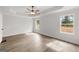 Spacious primary bedroom featuring two windows, wood-look floors, white walls, and a ceiling fan at 3229 Broadnax Mill Rd # 4, Loganville, GA 30052