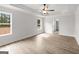 Bright bedroom featuring two windows, wood-look floors, white walls, and a ceiling fan at 3229 Broadnax Mill Rd # 4, Loganville, GA 30052