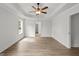 Spacious bedroom with a tray ceiling, ceiling fan, wood-look floors, and ample natural light at 3229 Broadnax Mill Rd # 4, Loganville, GA 30052