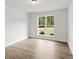 A bright bedroom with a large window, wood-look flooring, and ample natural light at 3229 Broadnax Mill Rd # 4, Loganville, GA 30052
