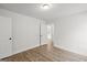 A bright bedroom with an open door, wood-look floors, and white walls at 3229 Broadnax Mill Rd # 4, Loganville, GA 30052