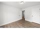 An empty bedroom with wood-look floors and white walls, ready for personalization at 3229 Broadnax Mill Rd # 4, Loganville, GA 30052