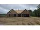 Exterior view of an unfinished house with a garage and wood construction material at 3229 Broadnax Mill Rd # 4, Loganville, GA 30052