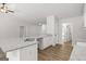 Kitchen featuring a granite island with a stainless sink and white cabinets at 3229 Broadnax Mill Rd # 4, Loganville, GA 30052