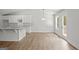 Open-concept living room with hardwood floors and a view into the kitchen with white cabinets at 3229 Broadnax Mill Rd # 4, Loganville, GA 30052
