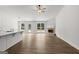 Living room featuring wood floors, fireplace, ceiling fan, and access to a kitchen and dining area at 3229 Broadnax Mill Rd # 4, Loganville, GA 30052