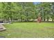 Large backyard features a patio with grill, playhouse, swing set and mature trees at 215 Calgary Dr., Peachtree City, GA 30269