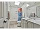 Bright bathroom with shower-tub combo, vanity, and skylight at 215 Calgary Dr., Peachtree City, GA 30269