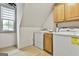 Bright laundry room equipped with washer, dryer, and overhead cabinets at 215 Calgary Dr., Peachtree City, GA 30269