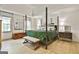 Spacious main bedroom with a four-poster bed, hardwood floors, and ample natural light at 215 Calgary Dr., Peachtree City, GA 30269