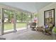 Cozy screened-in porch with outdoor seating provides a relaxing view of the backyard at 215 Calgary Dr., Peachtree City, GA 30269