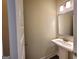Bathroom features a pedestal sink with a silver framed mirror above and light fixture with 2 lights at 542 Hinton Farm Way, Dacula, GA 30019