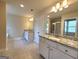 Bright bathroom featuring double vanities with granite countertops and tiled flooring at 542 Hinton Farm Way, Dacula, GA 30019