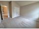 A bedroom features neutral carpeting, a double-door closet, and access to the en-suite bathroom at 542 Hinton Farm Way, Dacula, GA 30019