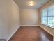 Bright bedroom featuring hardwood floors, neutral paint, and a large window providing ample natural light at 542 Hinton Farm Way, Dacula, GA 30019