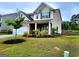 Beautifully landscaped front yard with a view of the two-story home, featuring a brick facade and well-maintained lawn at 542 Hinton Farm Way, Dacula, GA 30019